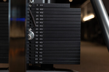 Different weight in the simulator for strength training in the gym