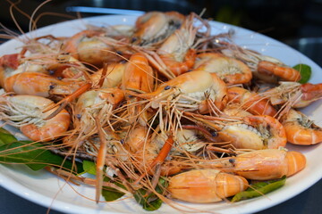 boiled shrimp Steamed shrimps with lemon and herbs. Seafood, shellfish. Shrimps prawns on plate.