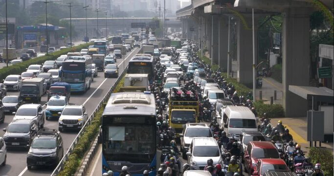 Many vehicles pass by in heavy traffic