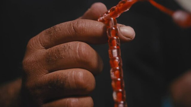Muslim man fingering prayer beads