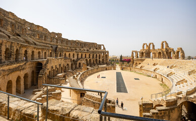 Impressive ruins of the largest colosseum in North Africa, huge Roman amphitheater in the small...