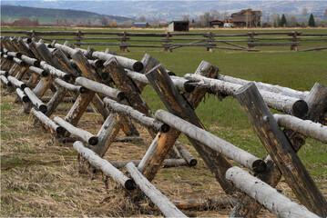buck fence side view with Steamboat Springs Colorado and grassy field in the background