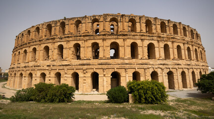 Impressive ruins of the largest colosseum in North Africa, huge Roman amphitheater in the small...