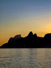 Sunset at sea with mountains silhouette