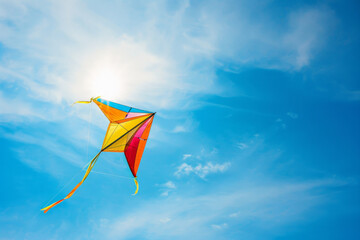 Colorful kite flying in a blue sky