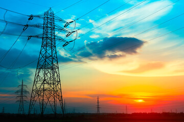 Fototapeta premium Silhouette of High voltage electric tower on sunset time background