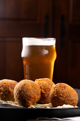 fried fish cake appetizer salmon cod with half pint of craft beer in pub
