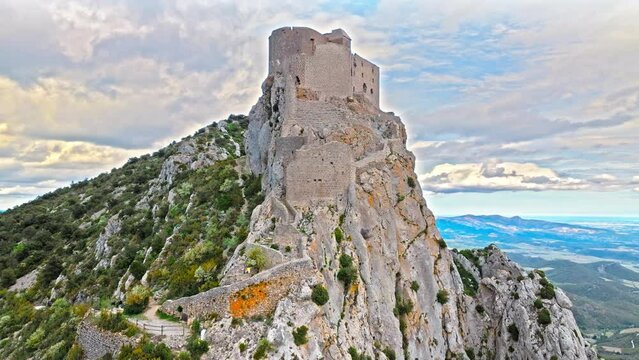 Aerial view of castle ruins perched on a craggy outcrop, with panoramic views from its tower terrace in France.
High fortress on the southern ridge of the Corbi&egrave;res, Ch&acirc;teau de Qu&eacute;ribus.
