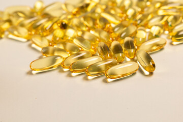 fish oil pills with omega 3 with a golden yellow color, an essential nutrient