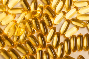 fish oil pills with omega 3 with a golden yellow color, an essential nutrient