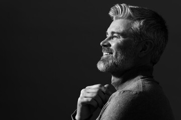 Portrait of smiling man on dark background, space for text. Black and white effect