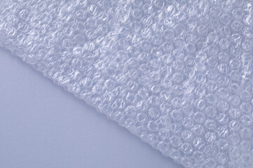Transparent bubble wrap on gray background, top view. Space for text