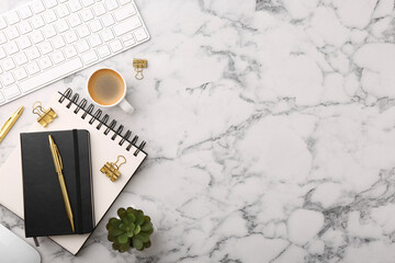 Flat lay composition with different office stationery on white marble table, space for text