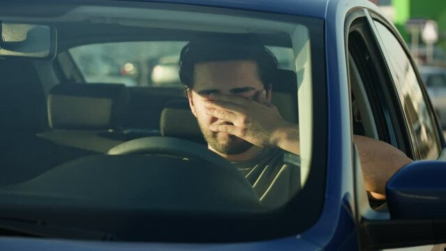 Man Driver Sitting in Car close-up, Traffic Jam. Car Sharing concept, Vehicle and Transport. Young Guy Driving. Traveling by Automobile, rush hour. 