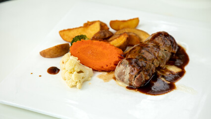 Served with sides of roasted potatoes, sliecd carrot and broccoli, delectable meal features grilled...