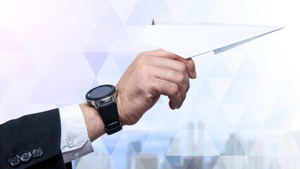 Business hand holding paper plane