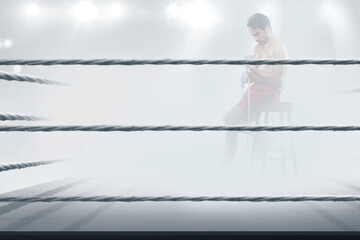 A boxer inside the ring with mist ready to fight for training session. An athlete doing train in the boxing arena for a championship.