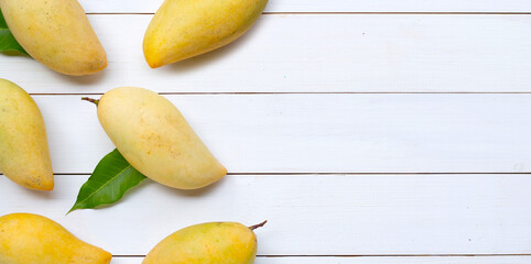 Tropical fruit, Mango on white wooden background.