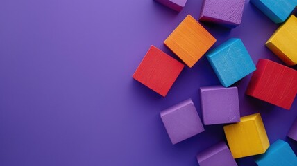Colorful wooden blocks scattered on purple surface