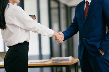 A woman shakes hands with a man in a suit