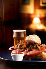 bock sausage sandwich with baguette crispy onion and pepper sauce paired with craft beer ale ipa...