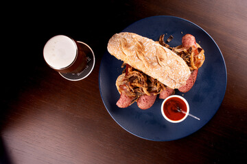 bock sausage sandwich with crispy onion baguette and pepper sauce paired with craft beer ale ipa...