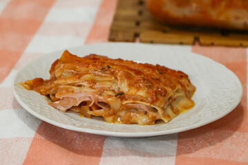 piece of hot lasagna on plate