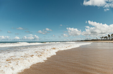 View of a tropical beach with clouds on the horizon in Porto de Galinhas, Brazil.