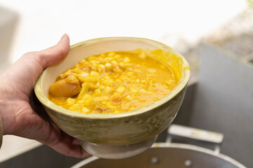 photography of locro, traditional Argentine food to celebrate national days with worker's day, May 25, July 9, with corn beans pig's feet meat pumpkin