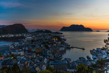 Fototapeta premium top view of a sunset over The city of Alesund and the sea during a sunny evening, Norway