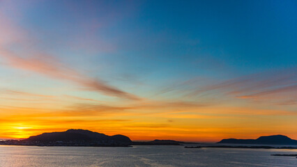 top view of a sunset over The city of Alesund and the sea during a sunny evening, Norway