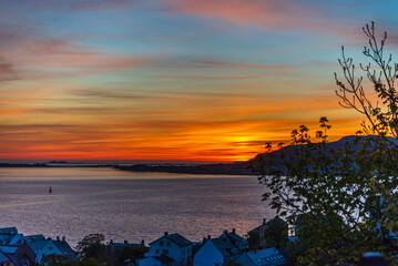 top view of a sunset over The city of Alesund and the sea during a sunny evening, Norway