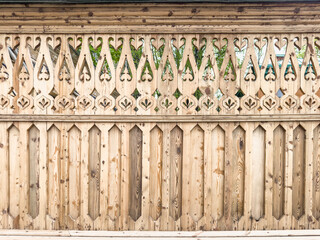 Fototapeta premium Background of a wooden carved fence. Natural wood texture.