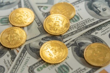 Golden bitcoin with dollar background. conceptual image for  currency.