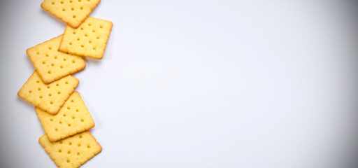 line of crackers put on white table with empty space