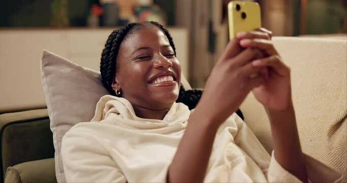 Black woman, couch and laughing with smartphone for social media, online comic and funny chat in home. Gen z girl, mobile and smile for internet joke with happy, meme and streaming video on sofa