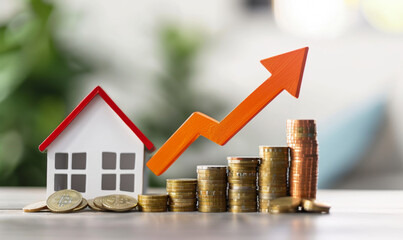 Stacks of coins, growing red arrow graph, house with red roof on blurred light background, Mortgage loan concept