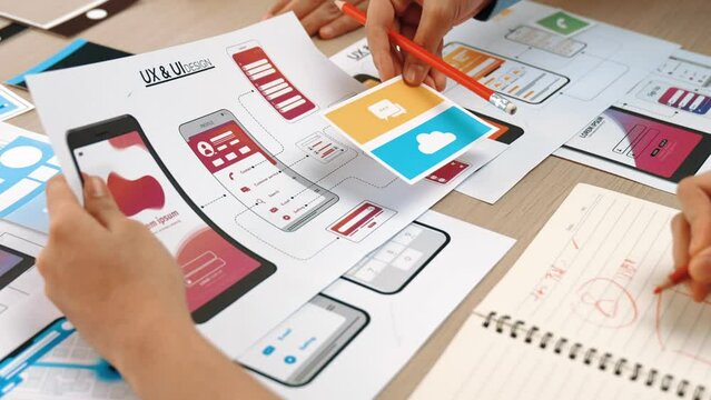 Panorama video of startup UX developer or company employee design user interface or UI prototype for mobile application or website software with software display on smartphone in office. Synergic