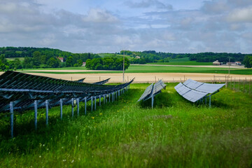Solar panels in a green grass field in France