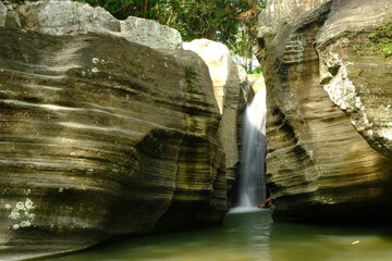 waterfall between sedimentary rock walls. natural background.