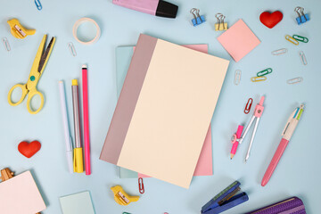 School supplies or stationery on blue background. Back to school concept.