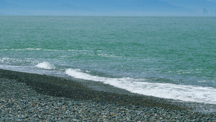 Azure Pure Foamy Texture. Blue Wave Cresting And Crashing Into Shore. Slow motion.