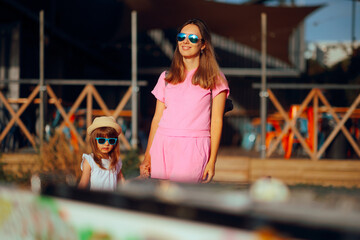 Mother and Daughter Wearing Sunglasses being on Vacation. Cheerful family traveling together...