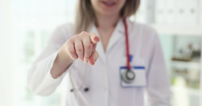 Doctor points his finger at camera in clinic