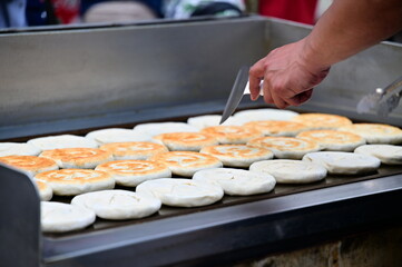 Experience the magic of Taiwanese street food as vendors craft crispy scallion pancakes bursting...