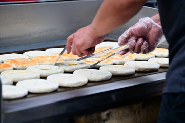 Experience the magic of Taiwanese street food as vendors craft crispy scallion pancakes bursting...
