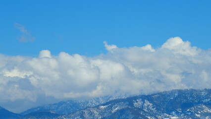 High Mountains. Mountain Range Peak Covered In Snow Blue Sky With Opposite Direction Clouds. Timelapse.