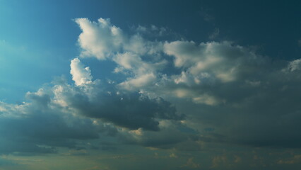 Cloudy Sky Background In Evening. Cloudscape Has Been Developing In Gorgeous Form. Blue And Yellow...