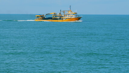Seafood Production In The Sea Or Ocean. Fishing Boat Sails In The Open Sea. Real time.