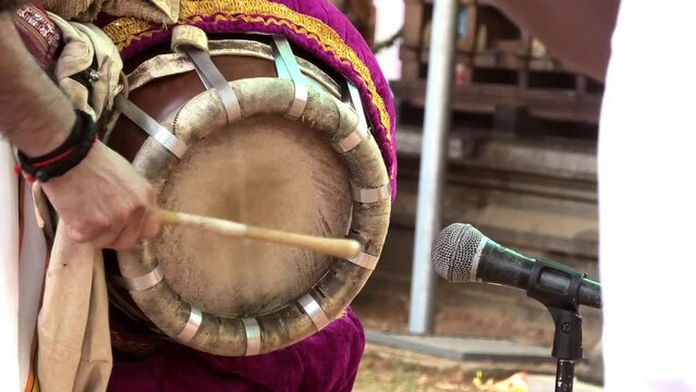 Artist playing Thavil, a South Indian percussion musical instrument	